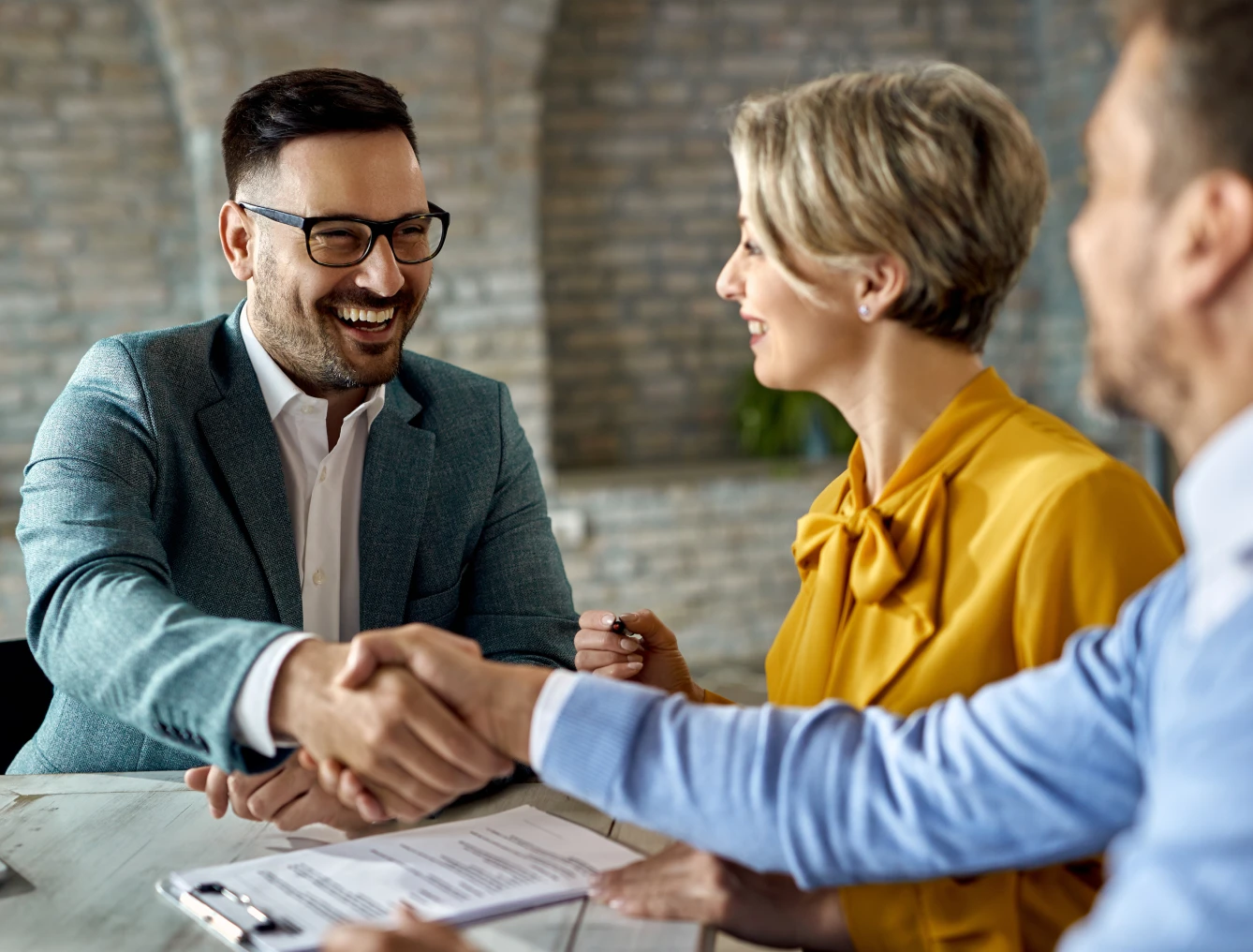 Smiling colleagues shaking hands